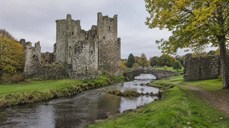 Free castle ruins beside a river in the English countryside
