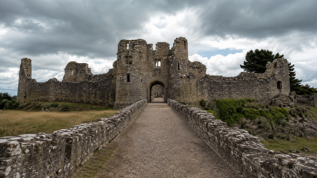 Pathway leading toward the stabilised stone ruins of a large castle gatehouse